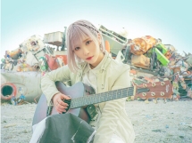 Image of ReoNa playing guitar
